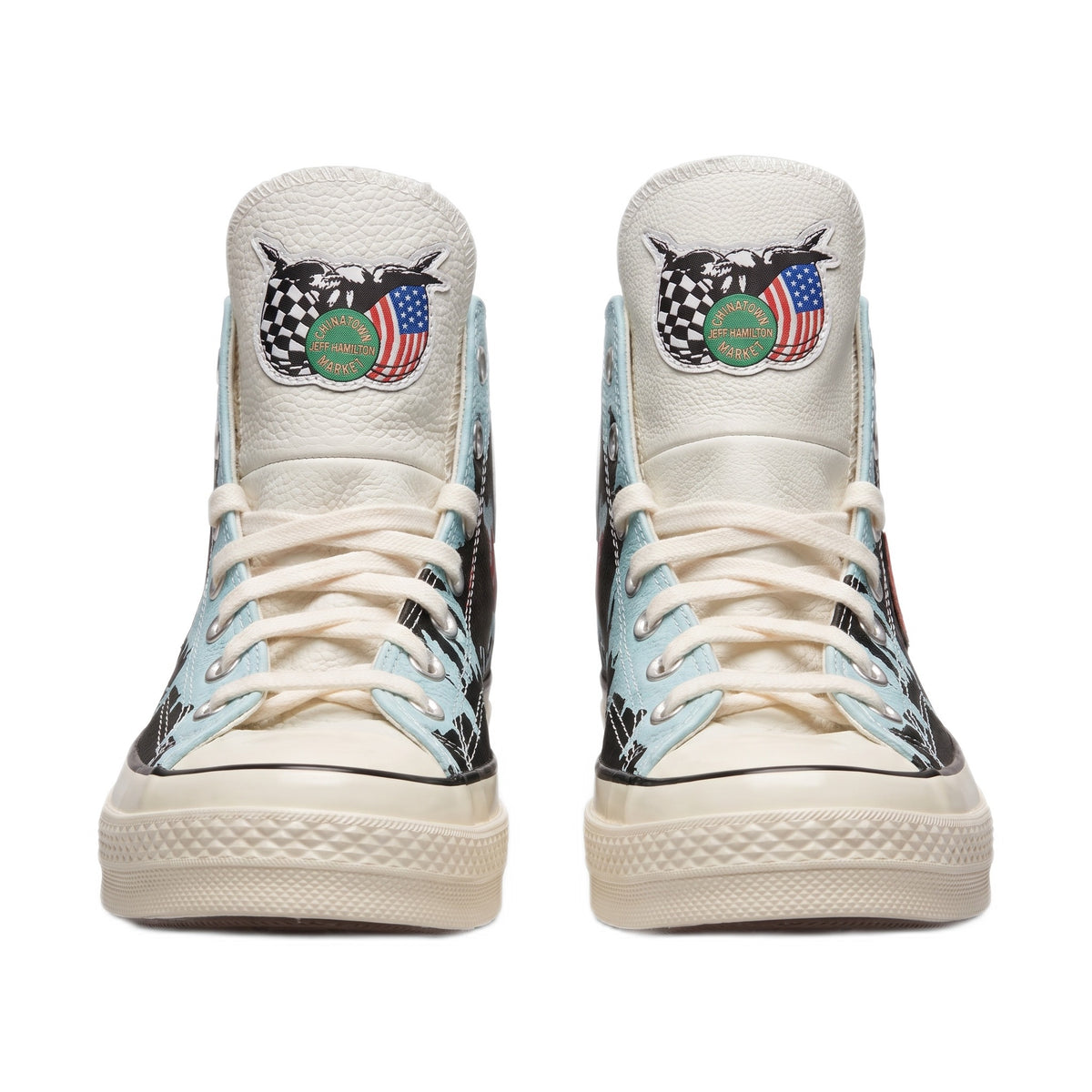 Front view of both shoes showing the tongue patches and cream laces.