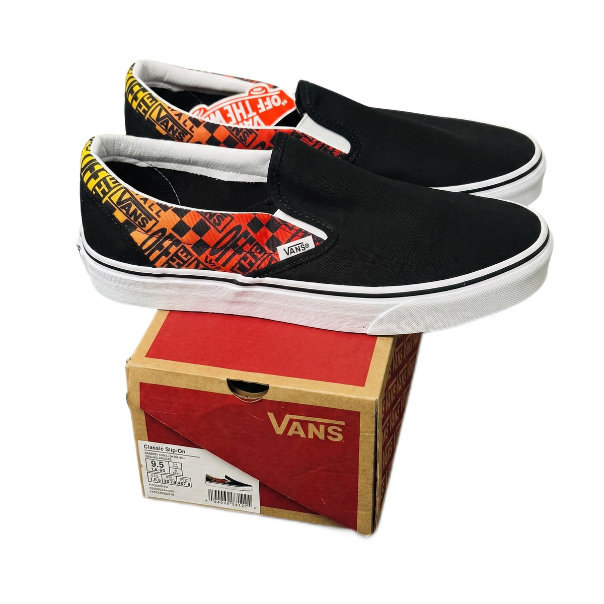 Three-quarter view of both slip-on shoes stacked on top of their original Vans cardboard box.