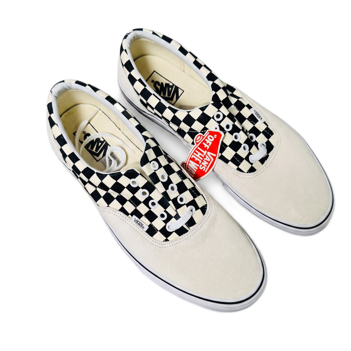 Three-quarter top view of cream and checkerboard sneakers on white background.
