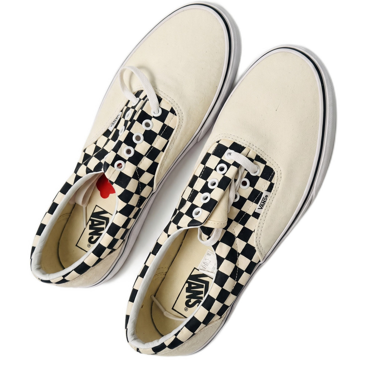 Top-down view of both sneakers showing the insoles and black-and-white checkers.