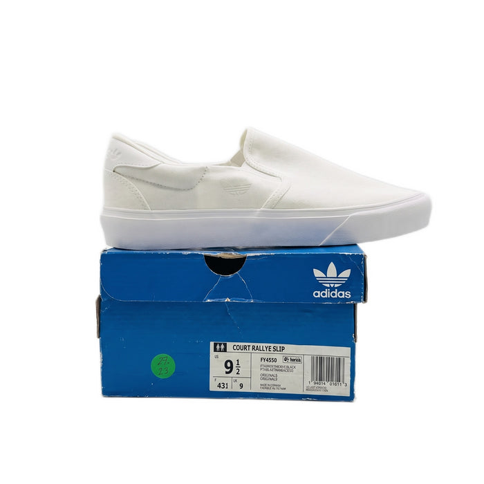 Side profile of one white slip-on sneaker sitting on top of a blue Adidas shoe box.