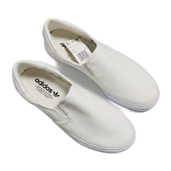 Top-down view of both white slip-on sneakers with tags attached, showing the insoles.