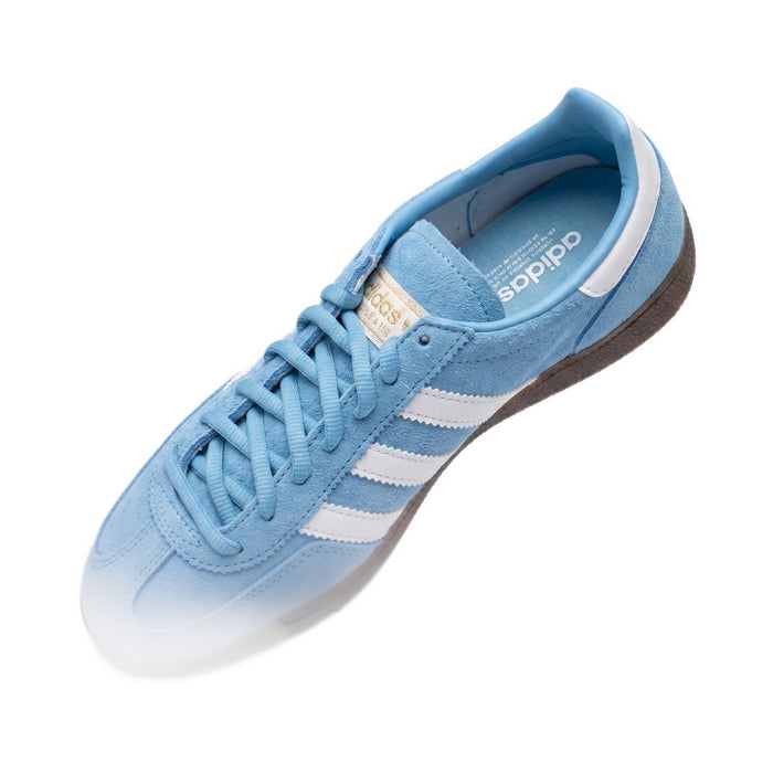 Top-down diagonal view of a single shoe showing the laces, gold tongue logo, and insole.