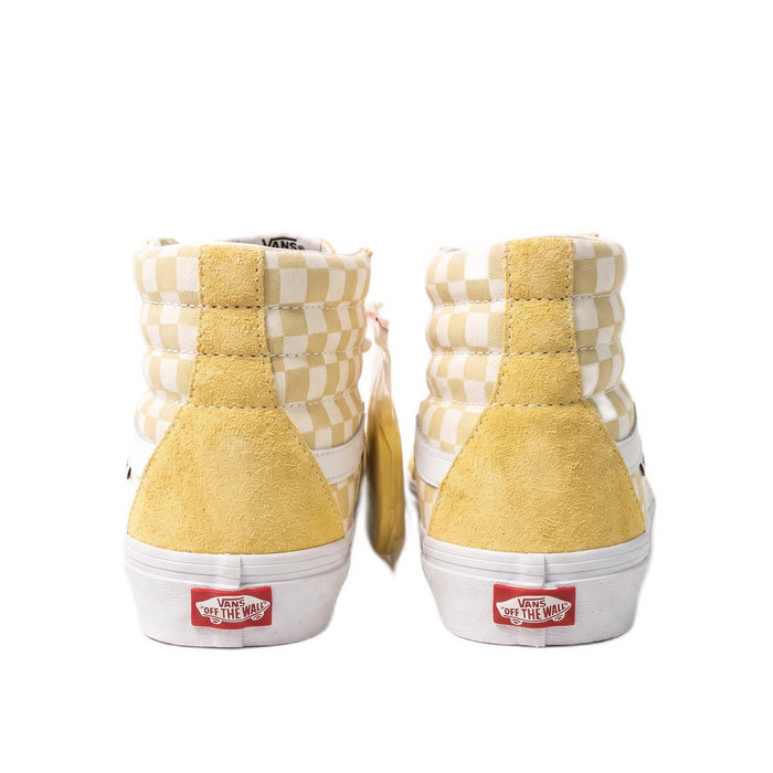 Heel view showing the rear of the yellow sneakers and red rubber heel tabs.