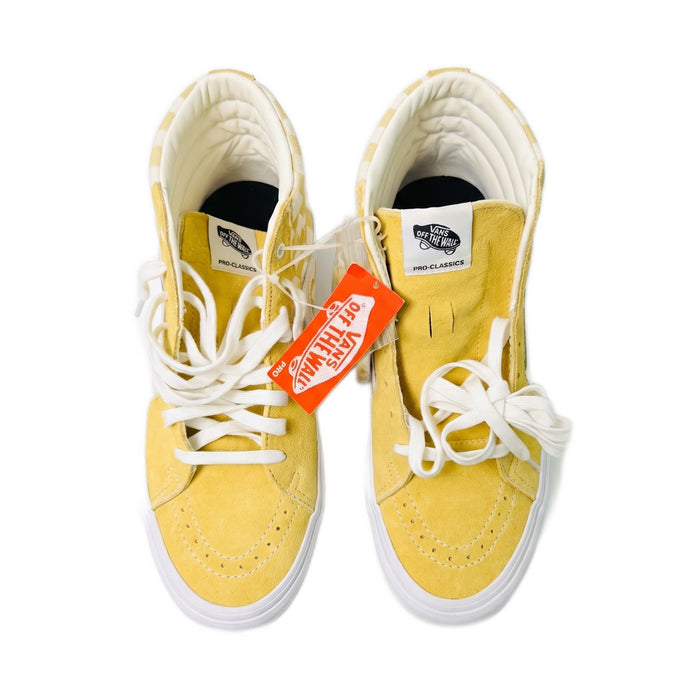 Top-down view of yellow high-top sneakers showing insoles and laces.