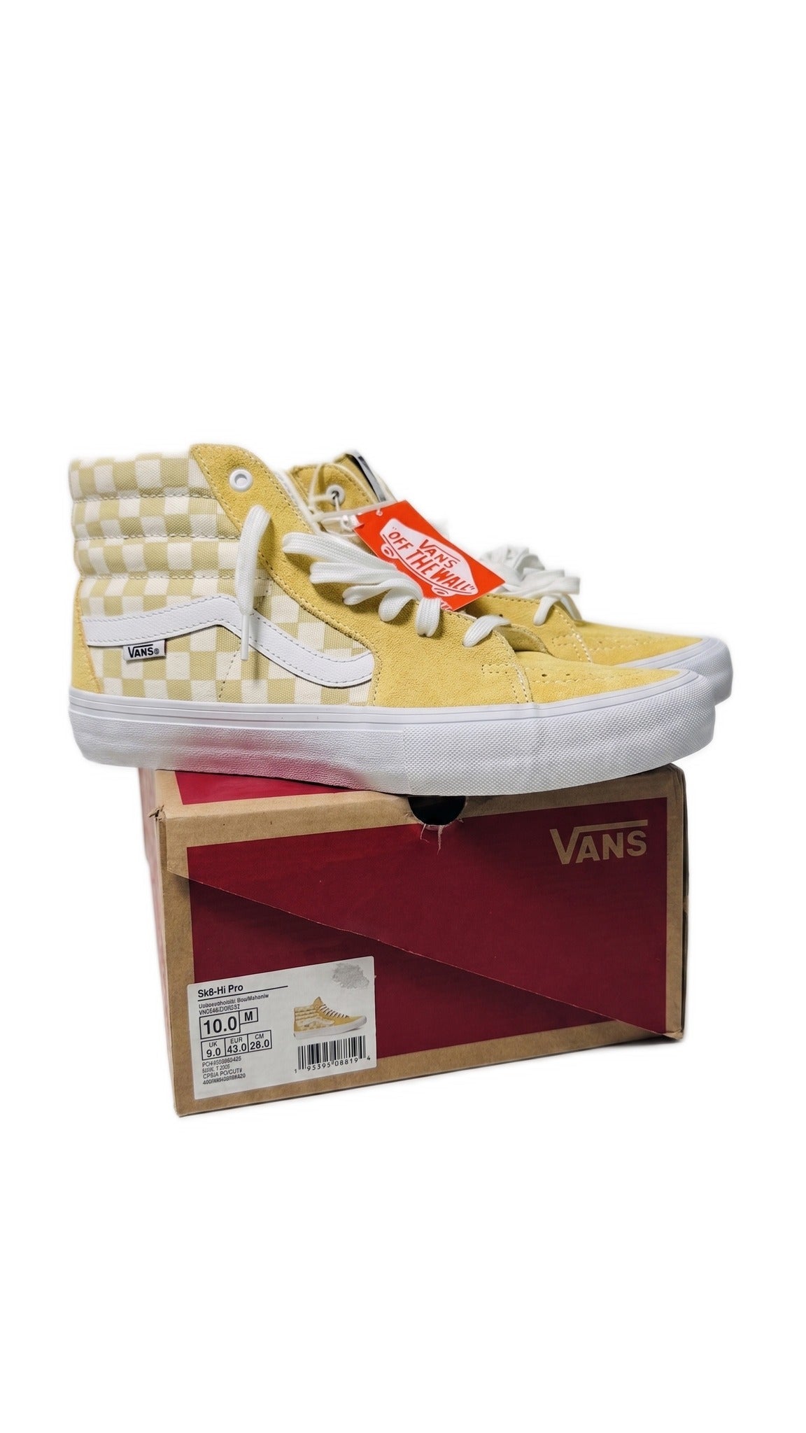 Side view of the yellow sneakers resting on top of their original cardboard shoe box.