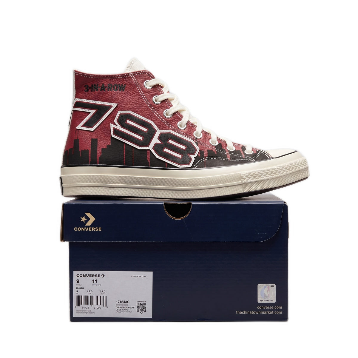 Close-up side profile of the left shoe resting on the blue Converse shoe box.
