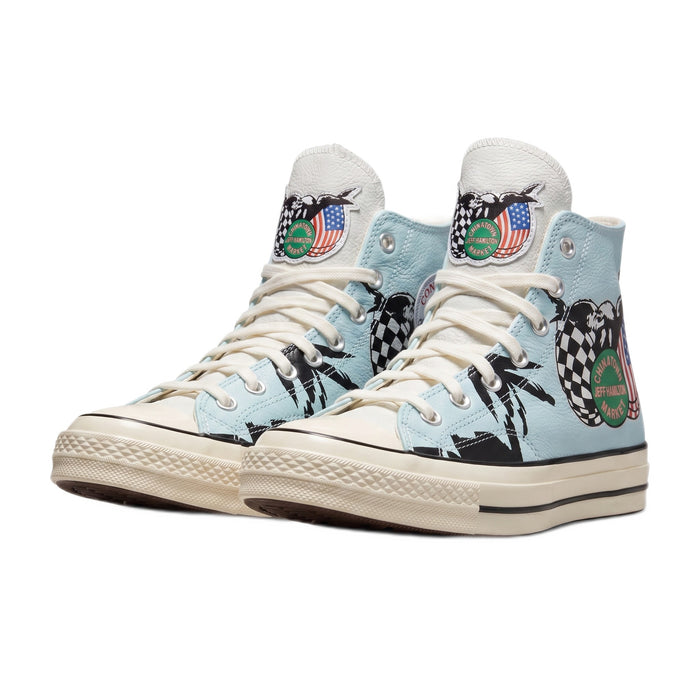 Three-quarter view of both light blue high-top sneakers with palm tree graphics.