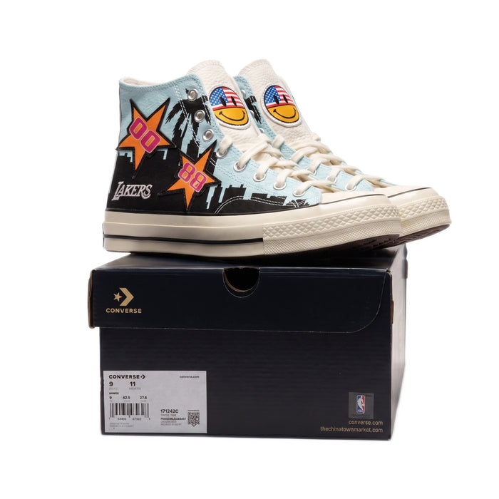 Side profile view of both shoes stacked on top of their black shoebox.