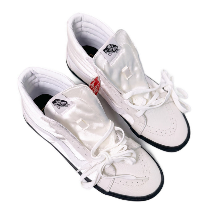 Overhead view of white high-top sneakers showing laces, tongues, and insoles.