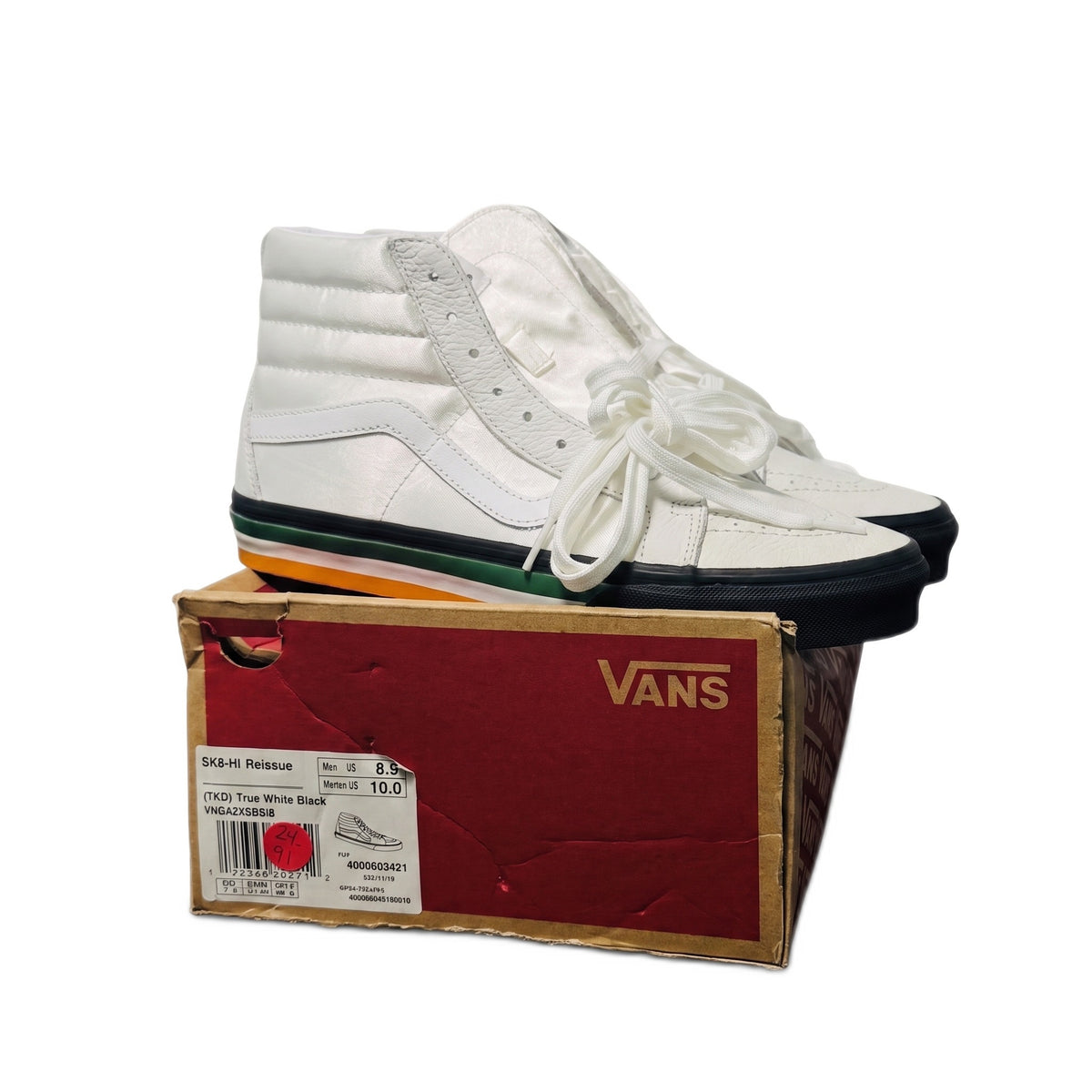 Side profile of a white shoe resting on top of a red and brown Vans shoebox with a size label.