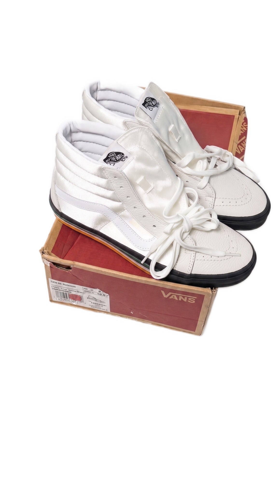 High-angle view of both white sneakers sitting on top of the red and brown shoebox.
