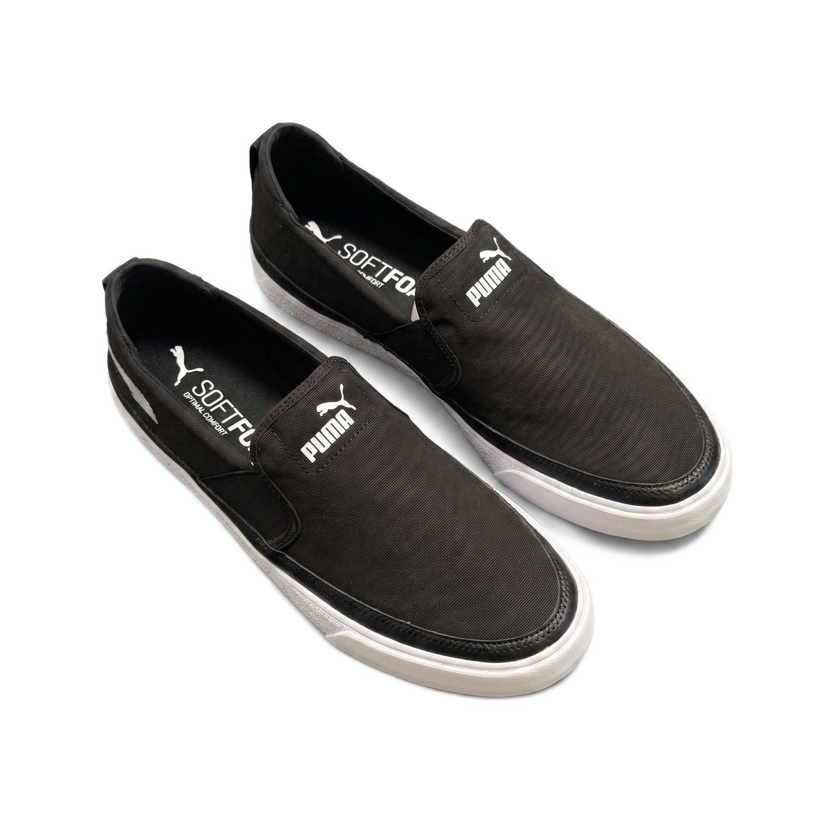 Three-quarter top view of the black canvas slip-on sneakers.