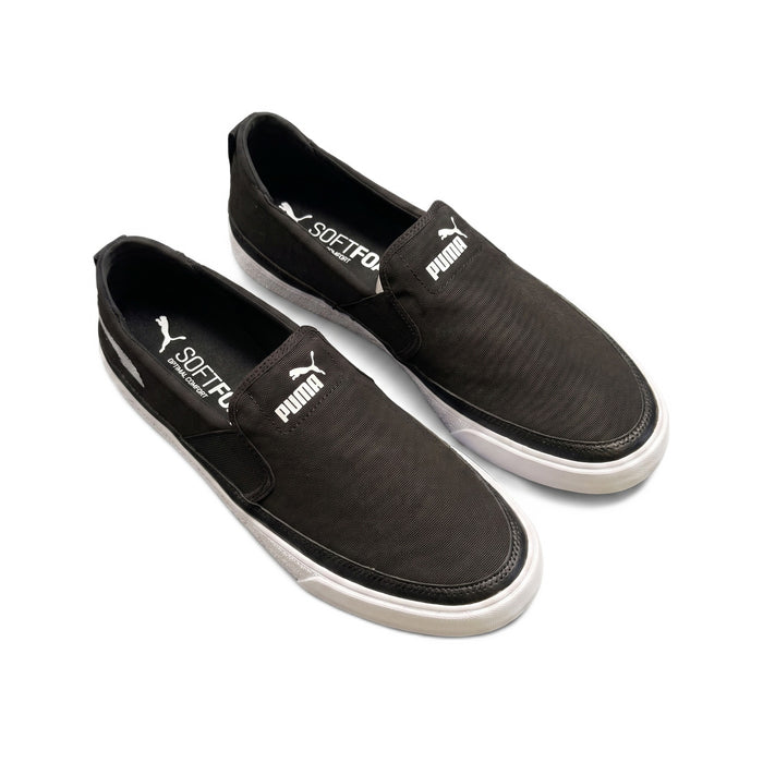 Three-quarter top view of the black canvas slip-on sneakers.