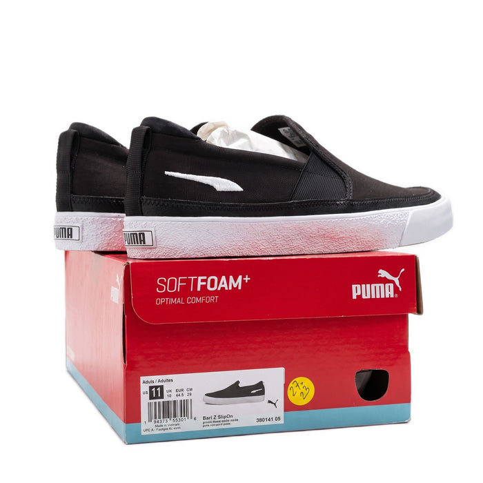 Side view of the sneakers on the red box, showing the side profile and barcode label.