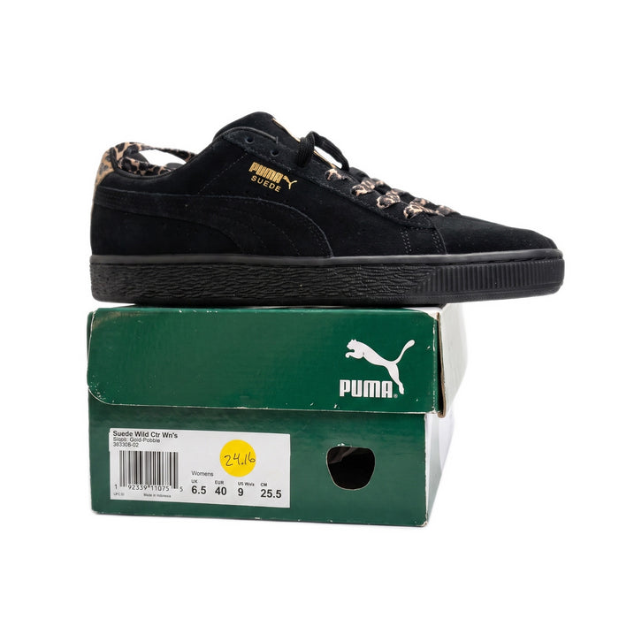 Side profile of one shoe resting on top of a green Puma shoebox with size label.