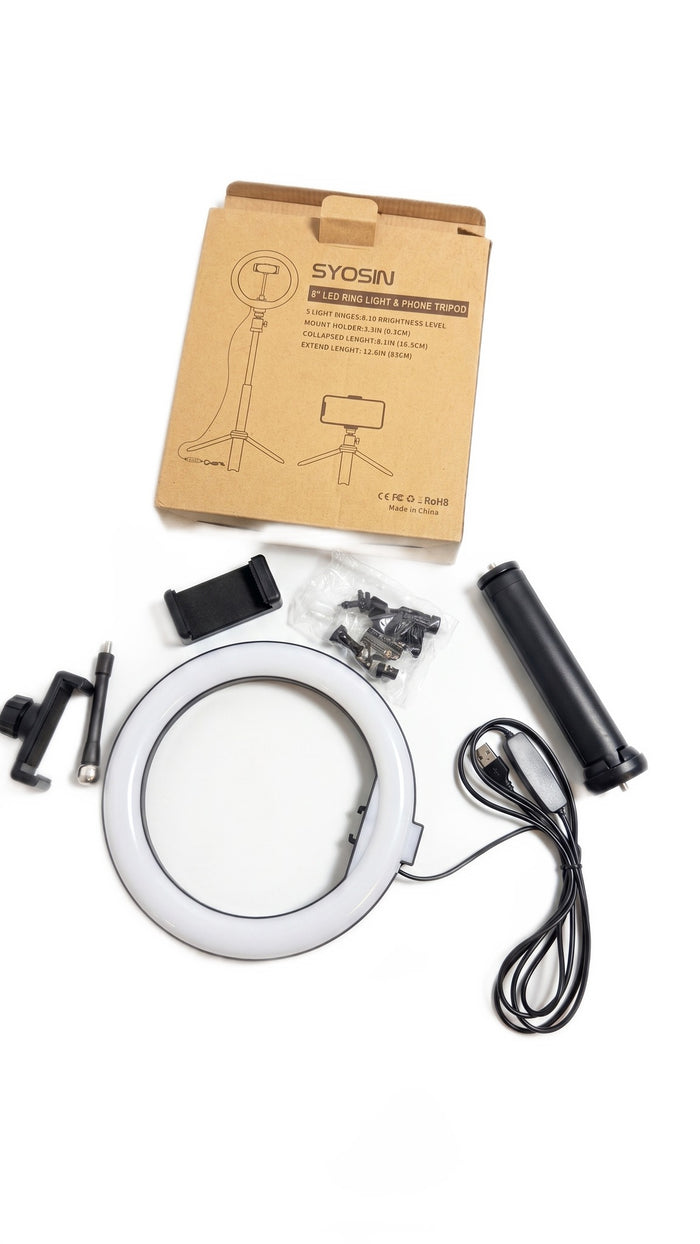 Top-down view of the ring light kit components laid out on a white background with its box.