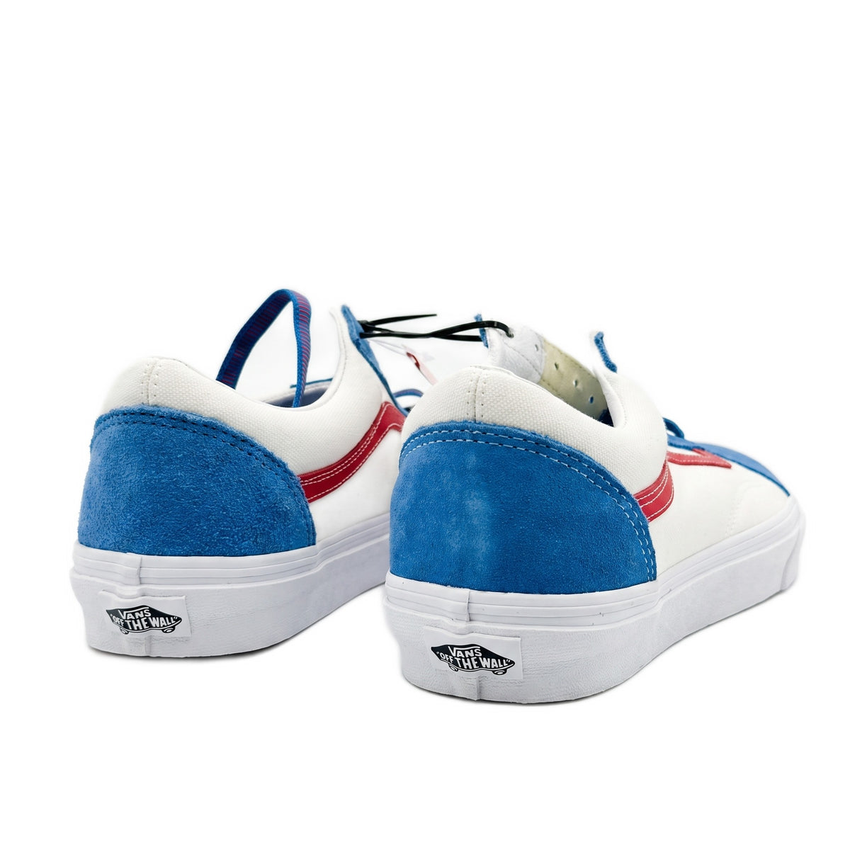 Heel view of the sneakers showing blue suede heels with white rubber logos.