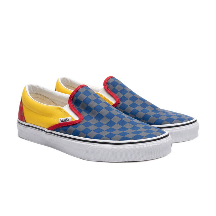 Three-quarter view of the checkerboard slip-on sneakers on a white background.
