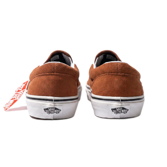 Rear view of the shoes with a red hangtag, showing white soles and black Vans logos.