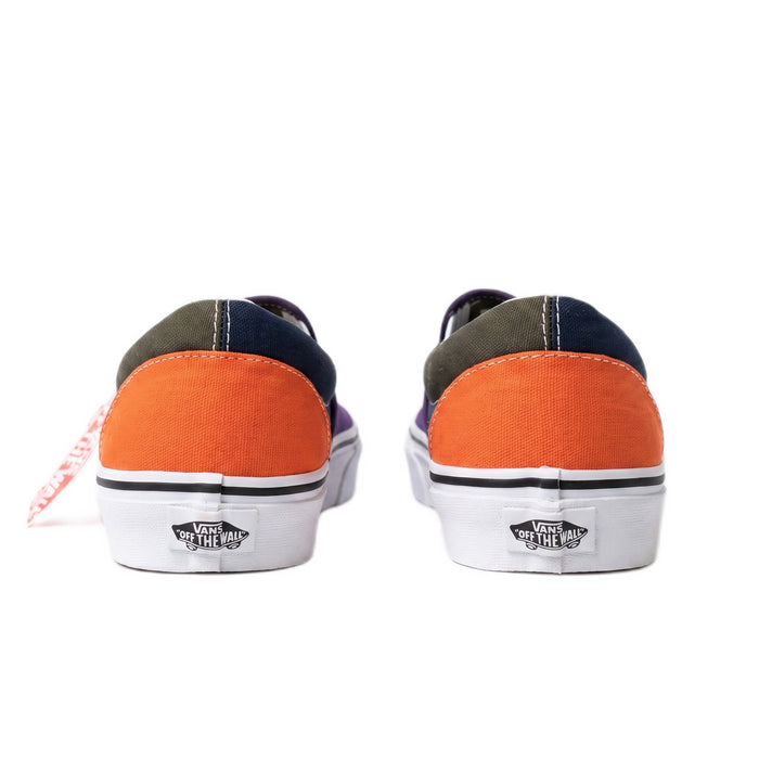 Heel view of the shoes showing green and orange canvas panels with red heel logos.