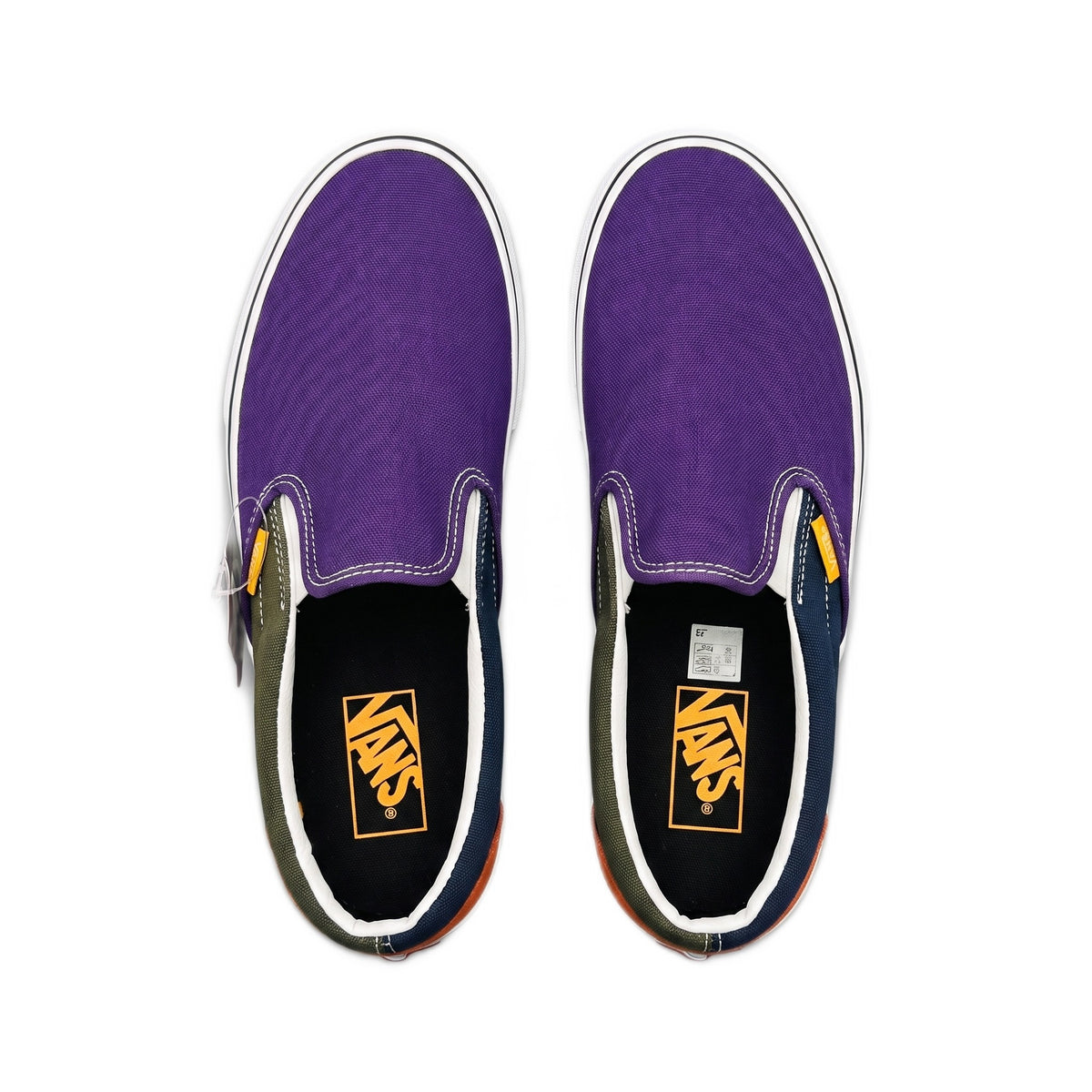 Top-down view of the shoes showing purple canvas uppers, elastic gores, and orange insoles.