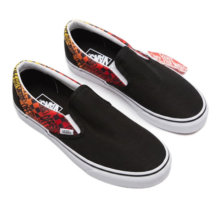 Three-quarter view of the black canvas slip-ons with flame-patterned collar trim and tags.