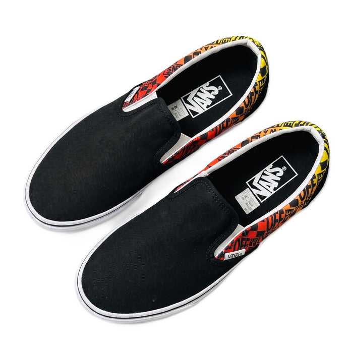 Top-down view of both slip-on shoes showcasing the black upper and branded insoles.