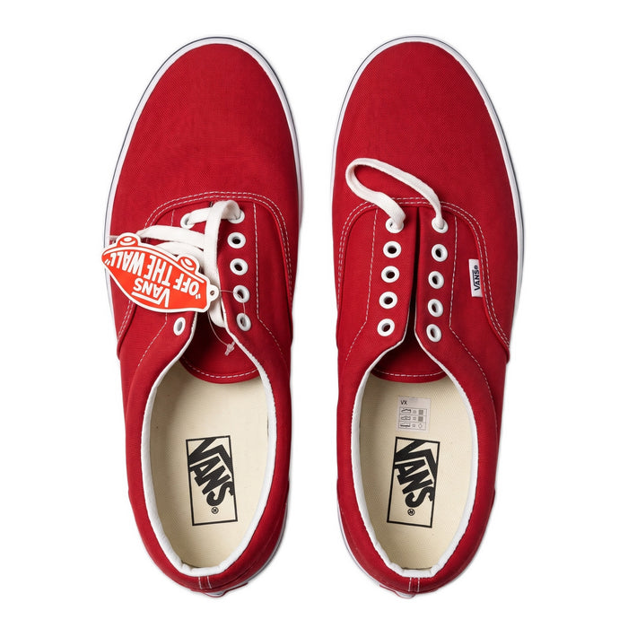 Top-down view of the pair of red sneakers with white insoles and laces.