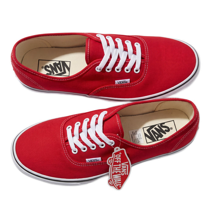 Top-down close-up view of both red sneakers side by side with tags attached.